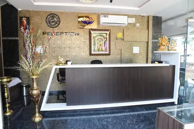 a lobby with a reception desk in a building at Yashas Paradise in Nanjangūd
