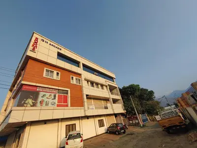 a building with a car parked in front of it at The Grand Inn in Kanjikode
