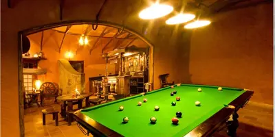 a pool table with balls on it in a room at Vythiri Resort in Vythiri