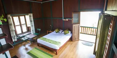 a bedroom with a bed in a room with wooden walls at Avadale Wayanad - Stag Groups Not Allowed in Kalpetta