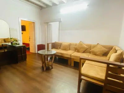 a living room with a couch and a table at Coorg Daffodil Guesthouse in Madikeri