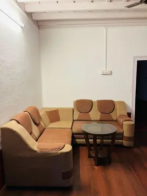 a living room with a couch and a table at Coorg Daffodil Guesthouse in Madikeri