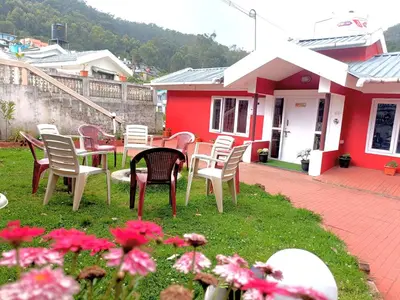 a group of chairs and tables in front of a house at QUEENS COTTAGE - individual cottage in Ooty