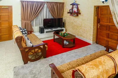 a living room with a couch and a tv at Belljem Homes -your own private resort -3 BHK GF in Trichūr