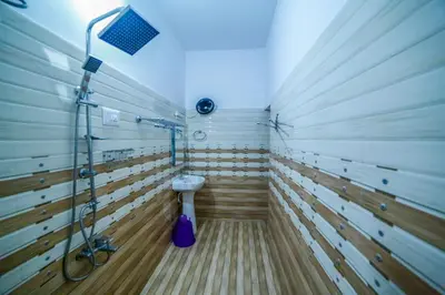 a bathroom with a shower and a toilet in it at Belljem Homes -your own private resort -3 BHK GF in Trichūr