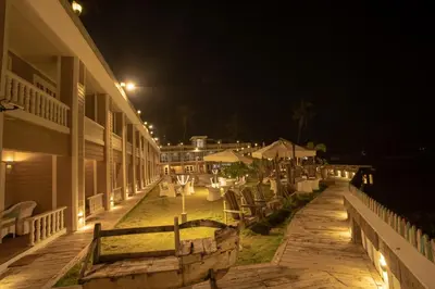a night view of a patio of a building at State Beach Resort And Spa in Kannur