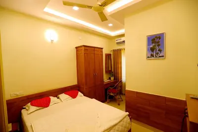 a bedroom with a bed with red pillows on it at SAPPHIRE INN in Nedumbassery