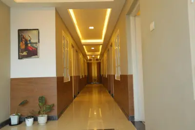 a hallway in a building with wooden floors and ceilings at SAPPHIRE INN in Nedumbassery