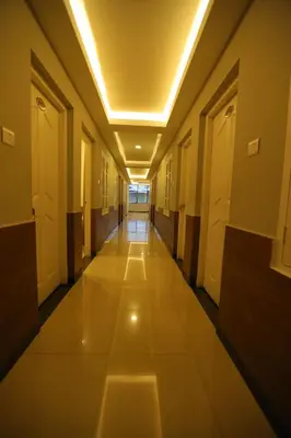 an empty hallway in a building with lights at SAPPHIRE INN in Nedumbassery