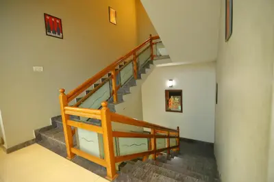 a staircase in a home with wooden railings at SAPPHIRE INN in Nedumbassery