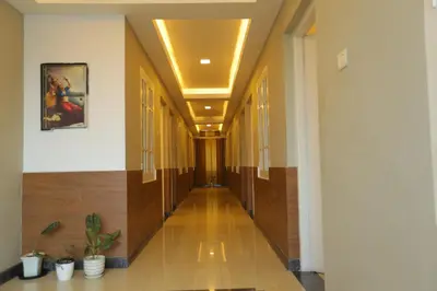 a hallway of a building with wooden floors and ceilings at SAPPHIRE INN in Nedumbassery
