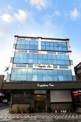 a building with a sign on the front of it at SAPPHIRE INN in Nedumbassery