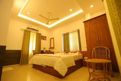a bedroom with a bed and a ceiling fan at SAPPHIRE INN in Nedumbassery