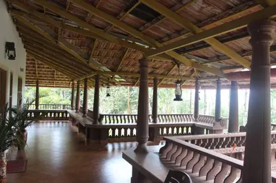 a large room with rows of benches in a building at Wayal Wayanad Honey moon villa in Panamaram