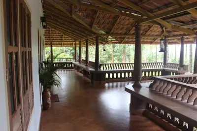 an empty room with benches in a building at Wayal Wayanad Honey moon villa in Panamaram