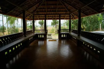 a room with a porch with a view of a field at Wayal Wayanad Twin Villa in Panamaram