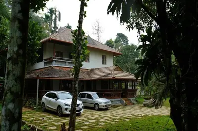 two cars parked in front of a house at Wayal Wayanad Twin Villa in Panamaram