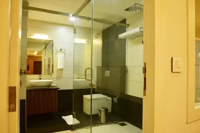a bathroom with a toilet and a sink at WHITE SUITE HOTEL in Kozhikode