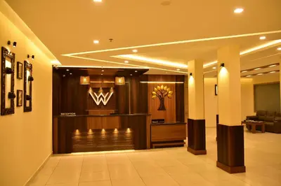 a hotel lobby with a reception desk and a wii at WHITE SUITE HOTEL in Kozhikode
