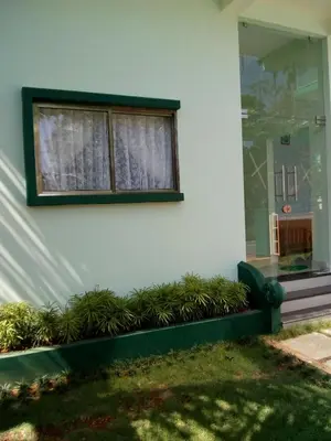 a window with plants in front of a building at ZaMaRaYa Bed & Breakfast in Angamali