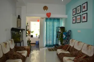a living room with two couches and a heart on the wall at EDEN Paradisee in Ooty