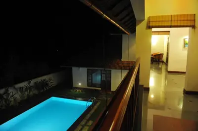 a swimming pool in the middle of a building at The Villa Romantica in Nedumbassery