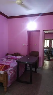 a purple room with a table and a bed at Dreams River view home stay coorg 2 in Kushālnagar