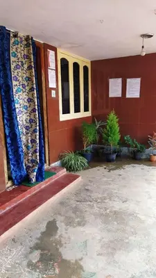a room with red walls and blue curtains and plants at Dreams River view home stay coorg 2 in Kushālnagar