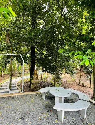 a picnic table and a bench in a park at Kayyalas Courtyard in Trichūr
