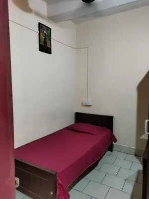 a bedroom with a red bed in a white wall at MALABAR Residency in Perintalmanna