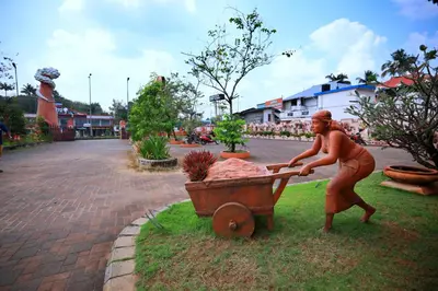 a statue of a woman pushing a cart at Clay House in Trichūr