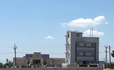 a building with a fence in front of it at Shantham Service Apartments, Kinathukadavu, Coimbatore in Coimbatore