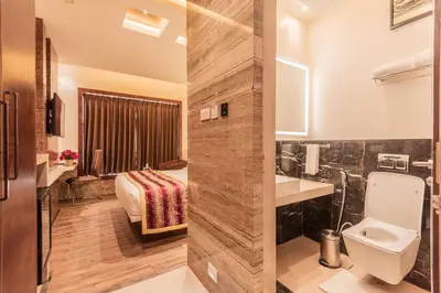 a bathroom with a sink and a toilet in a room at Hotel Park Elanza Coimbatore in Coimbatore