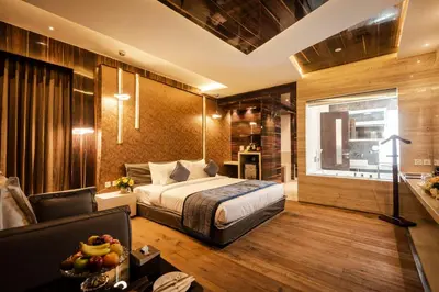 a bedroom with a bed and a couch at Hotel Park Elanza Coimbatore in Coimbatore
