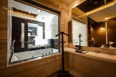a bathroom with a tub and a large window at Hotel Park Elanza Coimbatore in Coimbatore