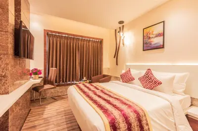 a hotel room with a large bed and a window at Hotel Park Elanza Coimbatore in Coimbatore