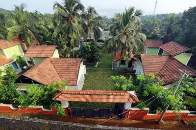 an aerial view of a group of houses with palm trees at NARMADA HOMESTAY Yamuna in Malappuram