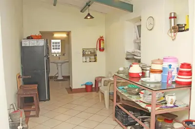a kitchen with a table with dishes on it at HS Holiday Home in Coonoor