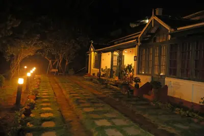 a street at night with lights next to a house at HS Holiday Home in Coonoor