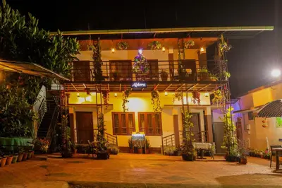 a building with a balcony with a christmas tree on it at Aldora Holiday Homes in Vythiri