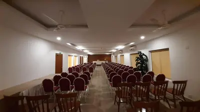 a room with a row of chairs in a hall at HOTEL SURYA in Iritti