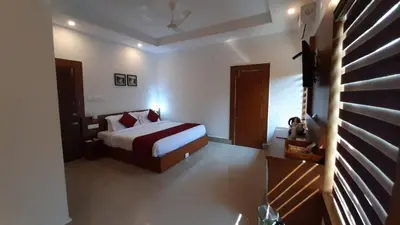 a bedroom with a bed and a television in it at HOTEL SURYA in Iritti