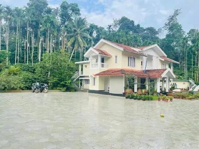 a house in the middle of a flooded street at Green Castle in Gonikoppal