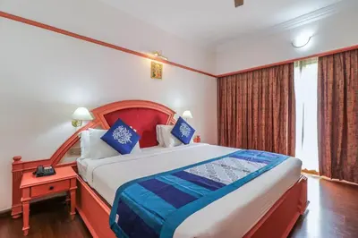 a bedroom with a large bed and a window at Fort Gate Hotels & Resorts in Trichūr