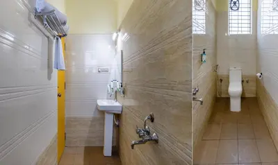 a bathroom with a sink and a shower at Treebo Four Seasons in Mysore