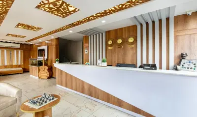 a lobby with a bar and a couch at Treebo Four Seasons in Mysore