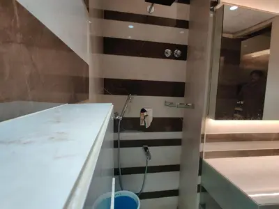 a bathroom with a shower and a sink at Neermala Residency in Coimbatore