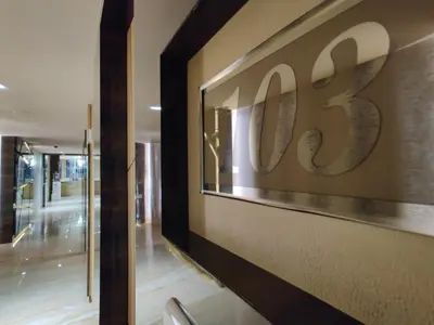 a lobby with a sign on the wall of a building at Neermala Residency in Coimbatore