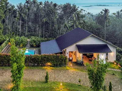 an aerial view of a house with a pool at Coffee Greens Resort in Wayanad