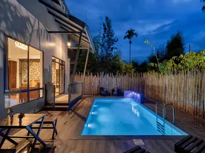 a swimming pool in the backyard of a house at Coffee Greens Resort in Wayanad